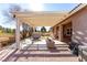 Comfortable covered patio features a stone barbecue island and textured concrete at 5552 Singing Hills Dr, Las Vegas, NV 89130