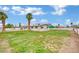 Large grassy backyard with fencing and outbuildings under a blue sky at 7060 S Valley View Blvd, Las Vegas, NV 89118