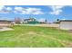 Large, lush backyard featuring mature trees and a privacy fence at 7060 S Valley View Blvd, Las Vegas, NV 89118