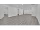 Finished basement with gray wood-look flooring and multiple doors for versatile use at 7060 S Valley View Blvd, Las Vegas, NV 89118