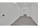 Finished basement with gray wood-look flooring, white walls, and a small window at 7060 S Valley View Blvd, Las Vegas, NV 89118