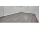 Finished basement with gray wood-look flooring and white walls offering a clean, modern look at 7060 S Valley View Blvd, Las Vegas, NV 89118