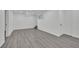 Finished basement with gray wood-look flooring, white walls, and bright, recessed lighting at 7060 S Valley View Blvd, Las Vegas, NV 89118