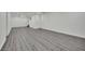 Finished basement with gray wood-look flooring and white walls for a modern, clean aesthetic at 7060 S Valley View Blvd, Las Vegas, NV 89118