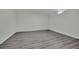Finished basement features gray wood-look flooring, white walls, and a small window at 7060 S Valley View Blvd, Las Vegas, NV 89118