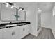 Modern bathroom with dual sinks, marble shower, and gray wood-look flooring at 7060 S Valley View Blvd, Las Vegas, NV 89118