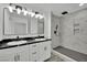 Modern bathroom boasts a dual sink vanity with marble countertops and a walk-in shower at 7060 S Valley View Blvd, Las Vegas, NV 89118