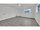 Bedroom featuring gray wood-look floors, bright natural light, and closet at 7060 S Valley View Blvd, Las Vegas, NV 89118