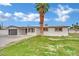 Single-story home with an attached garage, and a mature palm tree in the yard at 7060 S Valley View Blvd, Las Vegas, NV 89118