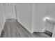 Hallway with hard floors leading to stairs, showcasing the seamless flow and neutral color palette at 7060 S Valley View Blvd, Las Vegas, NV 89118