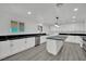 Updated kitchen features marble countertops, a central island, stainless steel appliances, and ample cabinet space at 7060 S Valley View Blvd, Las Vegas, NV 89118