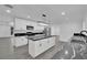 Bright kitchen featuring white cabinetry, marble counters, stainless steel appliances, and a center island at 7060 S Valley View Blvd, Las Vegas, NV 89118