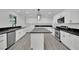 Modern kitchen featuring white cabinets, stainless steel appliances, and a large island with black marble countertops at 7060 S Valley View Blvd, Las Vegas, NV 89118