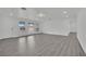 Bright living room with large windows and stylish gray wood-look flooring at 7060 S Valley View Blvd, Las Vegas, NV 89118