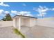 Exterior view of a stucco outbuilding with two entrances and rock landscaping at 7060 S Valley View Blvd, Las Vegas, NV 89118