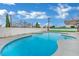 Large backyard pool surrounded by concrete, offering a serene escape and ample space for enjoyment at 7060 S Valley View Blvd, Las Vegas, NV 89118