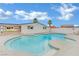 Backyard pool is surrounded by a concrete deck, perfect for relaxing and entertaining under the bright sky at 7060 S Valley View Blvd, Las Vegas, NV 89118