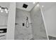 Marble-tiled shower with black fixtures, a handheld sprayer, and recessed shelving offers style and function at 7060 S Valley View Blvd, Las Vegas, NV 89118