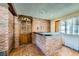 Indoor bar area featuring brick walls, wood doors, and counter space at 7079 Laredo St, Las Vegas, NV 89117