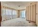 Spacious bedroom featuring striped wallpaper, bright windows, and natural light at 7079 Laredo St, Las Vegas, NV 89117