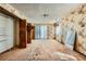 Bright bedroom featuring floral wallpaper, closet, and natural light, creating a cozy atmosphere at 7079 Laredo St, Las Vegas, NV 89117