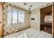 Eat-in kitchen with vintage wallpaper, window and hanging light fixture at 7079 Laredo St, Las Vegas, NV 89117