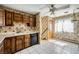 Eat-in kitchen showcasing linoleum floor, wood cabinets, floral wallpaper and natural light at 7079 Laredo St, Las Vegas, NV 89117