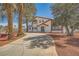 Stunning exterior featuring mature trees, desert landscaping, and a long driveway at 7079 Laredo St, Las Vegas, NV 89117