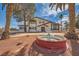 Two-story home featuring a fountain, palm trees, a second story balcony and desert landscaping at 7079 Laredo St, Las Vegas, NV 89117
