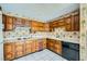 Retro kitchen featuring wood cabinets, laminate countertops, and tiled floor at 7079 Laredo St, Las Vegas, NV 89117