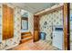Laundry room featuring a washer, floral wallpaper, and open access to the kitchen at 7079 Laredo St, Las Vegas, NV 89117