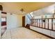 A spacious, light-filled living room featuring a fireplace, staircase, and tile flooring at 7079 Laredo St, Las Vegas, NV 89117