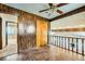 Unique Living Room with wood paneling, tile floor, and exposed staircase at 7079 Laredo St, Las Vegas, NV 89117