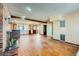 Open layout living room with brick fireplace, exposed beam, and large windows at 7079 Laredo St, Las Vegas, NV 89117
