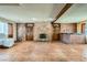 Large living room featuring brick fireplace and bar, offering a cozy and stylish space for gatherings at 7079 Laredo St, Las Vegas, NV 89117