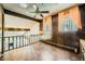 Unique Living Room with wood paneling, tile floor, and exposed staircase at 7079 Laredo St, Las Vegas, NV 89117
