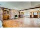 Open-concept living room featuring a classic fireplace, a vintage bar area, and unique flooring at 7079 Laredo St, Las Vegas, NV 89117