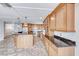 Kitchen with wood cabinets, granite counters, and an island at 720 Scottsdale St, Henderson, NV 89002