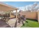 Backyard featuring covered patio, outdoor kitchen and built-in grill, seating, and artificial grass at 7621 Gosport Ave, Las Vegas, NV 89131