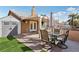Backyard featuring covered patio, outdoor kitchen with built-in grill, seating, and artificial grass at 7621 Gosport Ave, Las Vegas, NV 89131