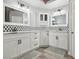 Bathroom featuring white cabinets, dual sinks, tile backsplash, and wood-look floors at 7621 Gosport Ave, Las Vegas, NV 89131