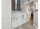 Bright bathroom featuring a bathtub, tiled walk-in shower, and wood-look vinyl flooring at 7621 Gosport Ave, Las Vegas, NV 89131