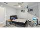 Bedroom features a mounted TV, desk setup, ceiling fan, and minimalist design elements at 7621 Gosport Ave, Las Vegas, NV 89131