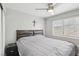 Cozy bedroom with a ceiling fan and a large window letting in plenty of natural light at 7621 Gosport Ave, Las Vegas, NV 89131