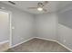 Bedroom featuring carpet, gray walls, a ceiling fan, and a white door to the hallway at 7621 Gosport Ave, Las Vegas, NV 89131