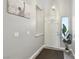 Inviting entryway featuring grey plank flooring, a decorative plant, art, overhead light fixture, and white trim at 7621 Gosport Ave, Las Vegas, NV 89131