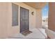 A welcoming entrance, featuring a secure decorative screen door, a light fixture, and a 'Welcome to our Home' doormat at 7621 Gosport Ave, Las Vegas, NV 89131
