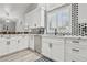 Bright kitchen with stainless steel appliances, white cabinetry, and dining area with bar stools at 7621 Gosport Ave, Las Vegas, NV 89131