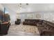 Comfortable living room features a ceiling fan, plush sectional seating, and a large TV for relaxation at 7621 Gosport Ave, Las Vegas, NV 89131