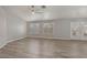 Spacious living room with ceiling fan, wood-style flooring, and plantation shutters at 7621 Gosport Ave, Las Vegas, NV 89131